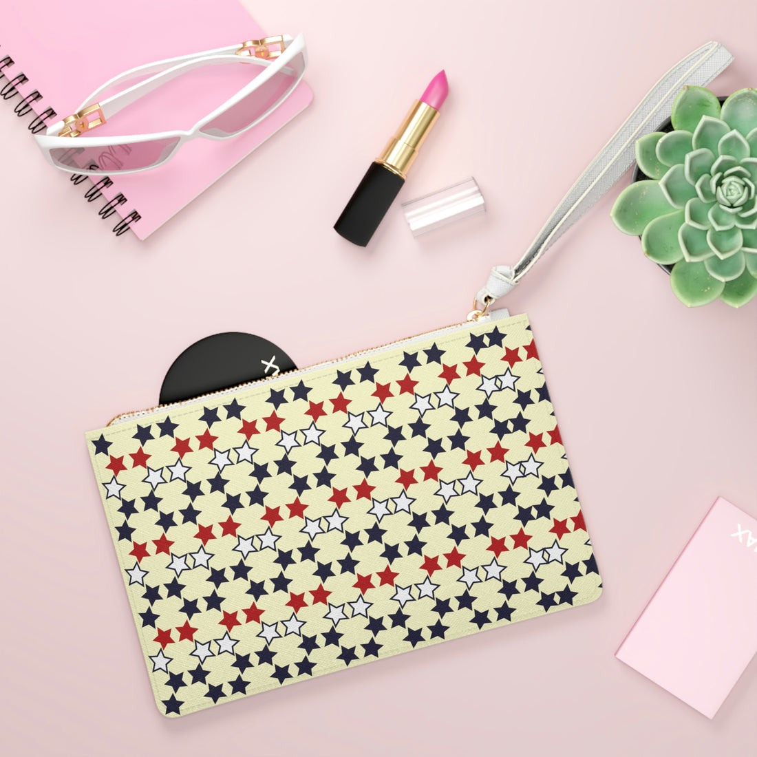 cream star print clutch bag